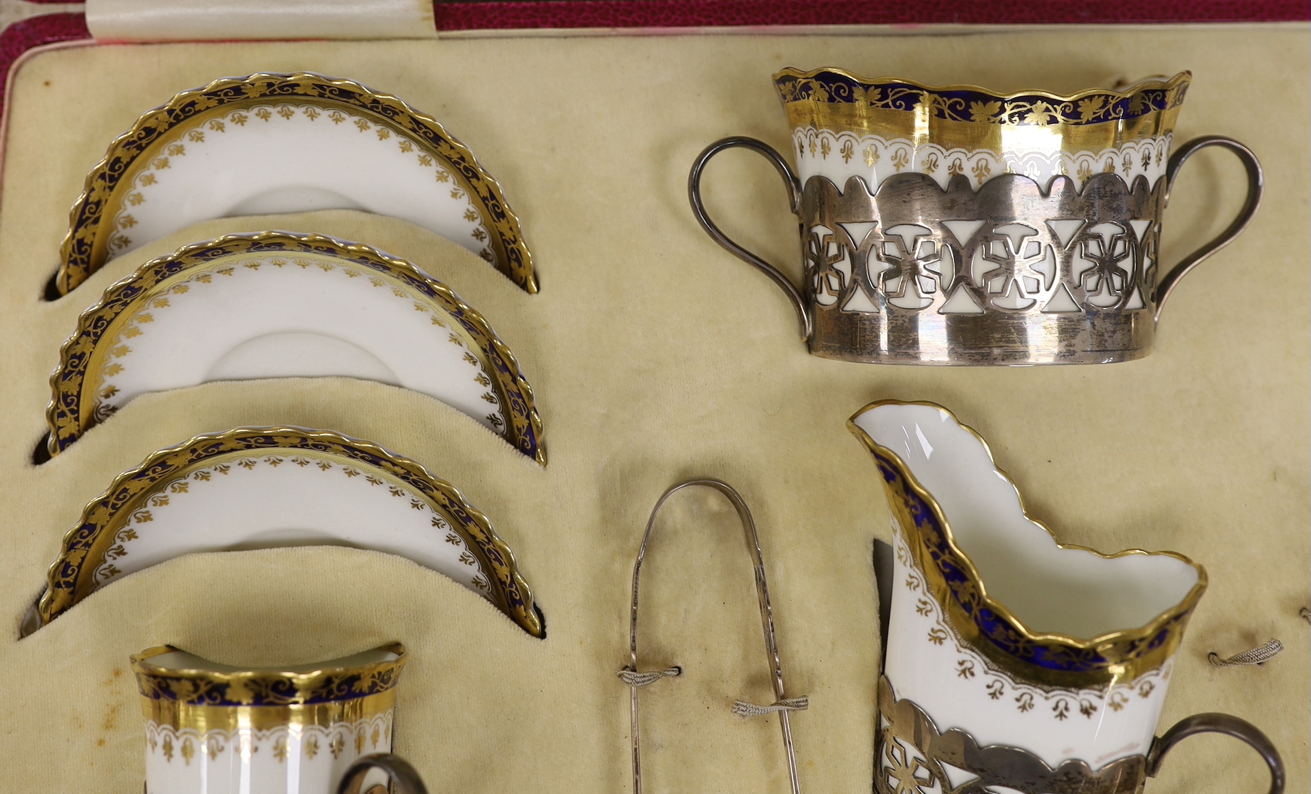 A cased George Jones Crescent China silver mounted coffee set, marks for Alexander Clark Co Ltd Sheffield 1928